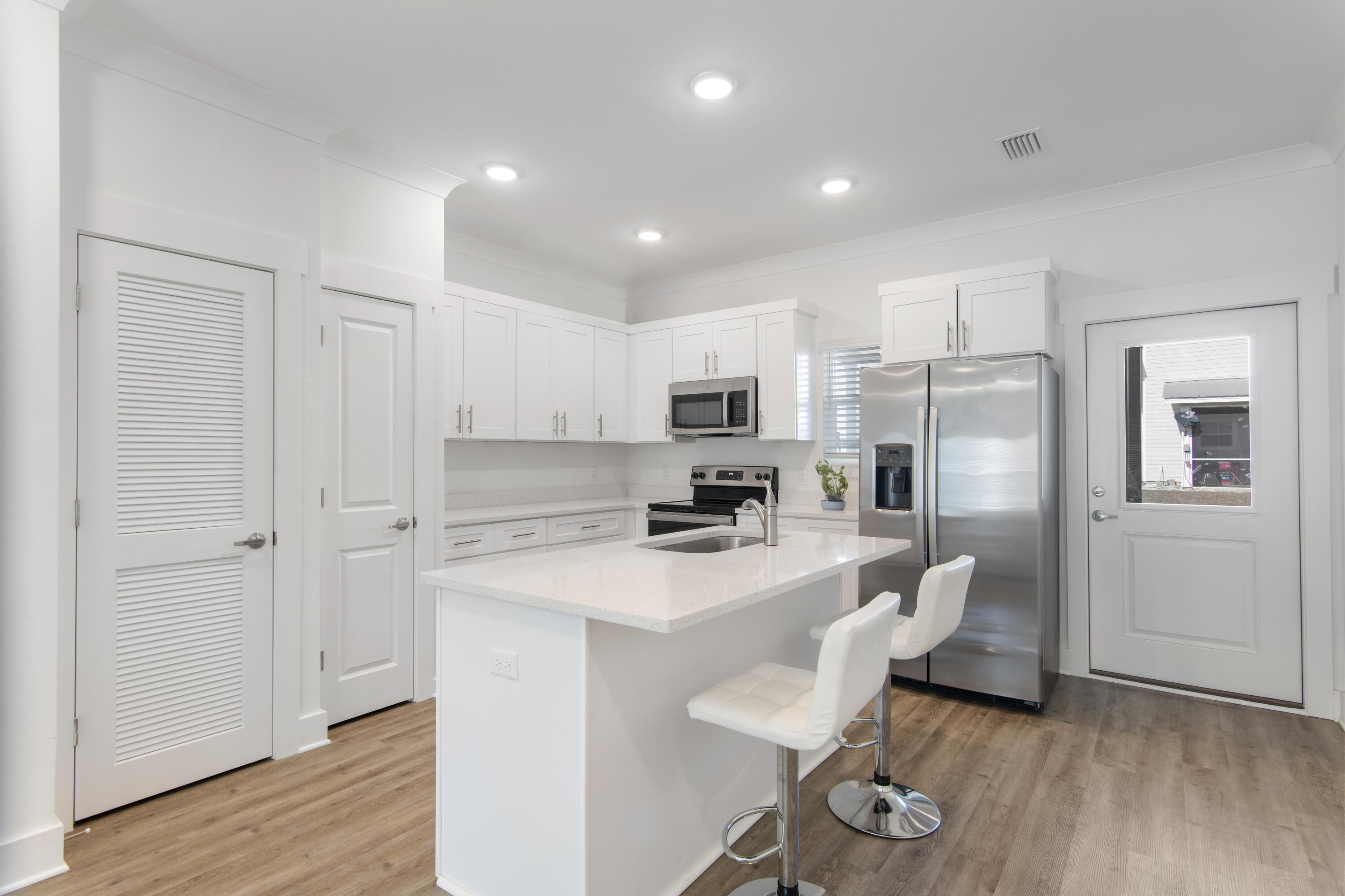 16 Date Palm Lane Freeport, FL 32439 - Photo 4 of 35 a kitchen with refrigerator cabinets and wooden floor