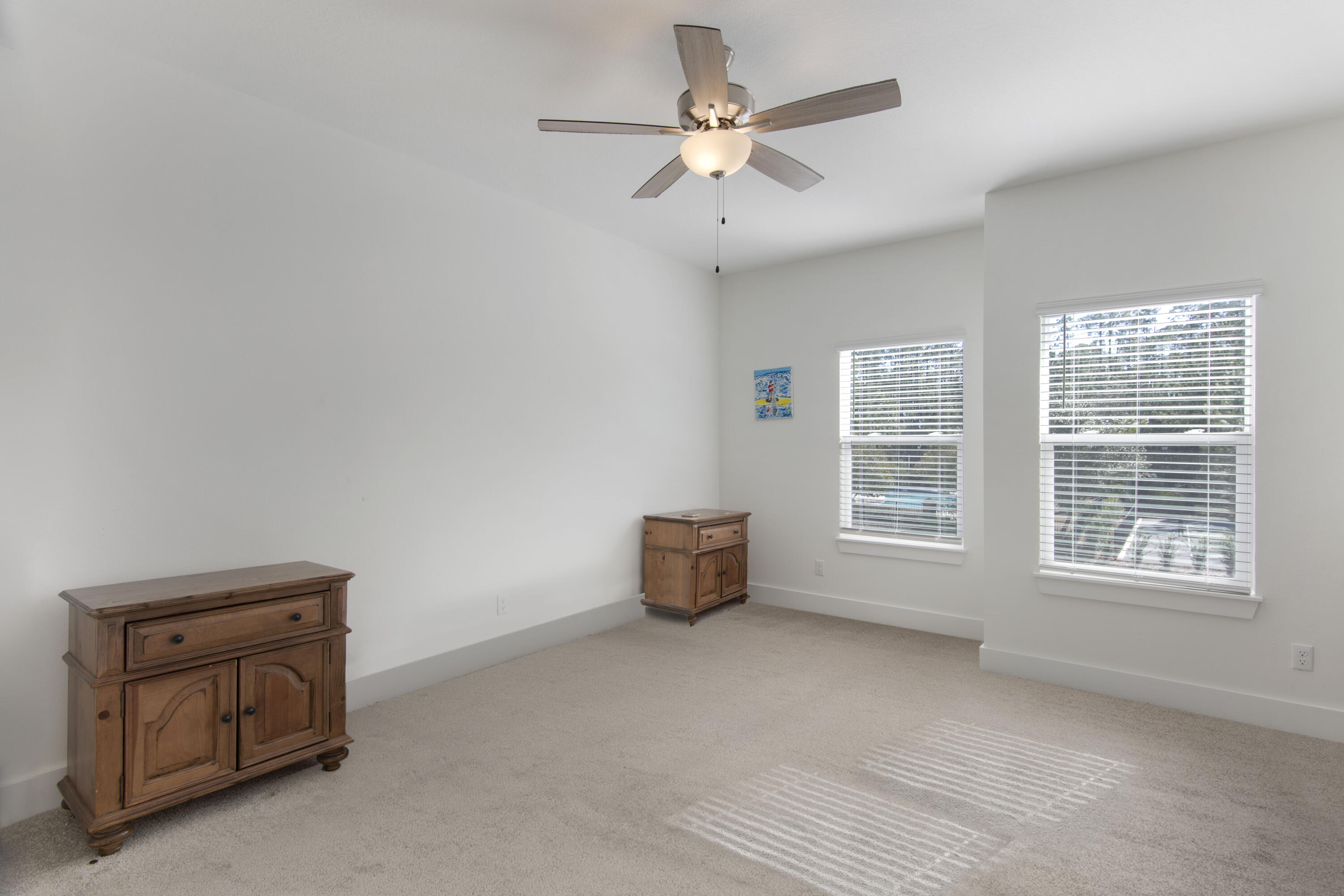 16 Date Palm Lane Freeport, FL 32439 - Photo 10 of 35 an empty room with windows and ceiling fan