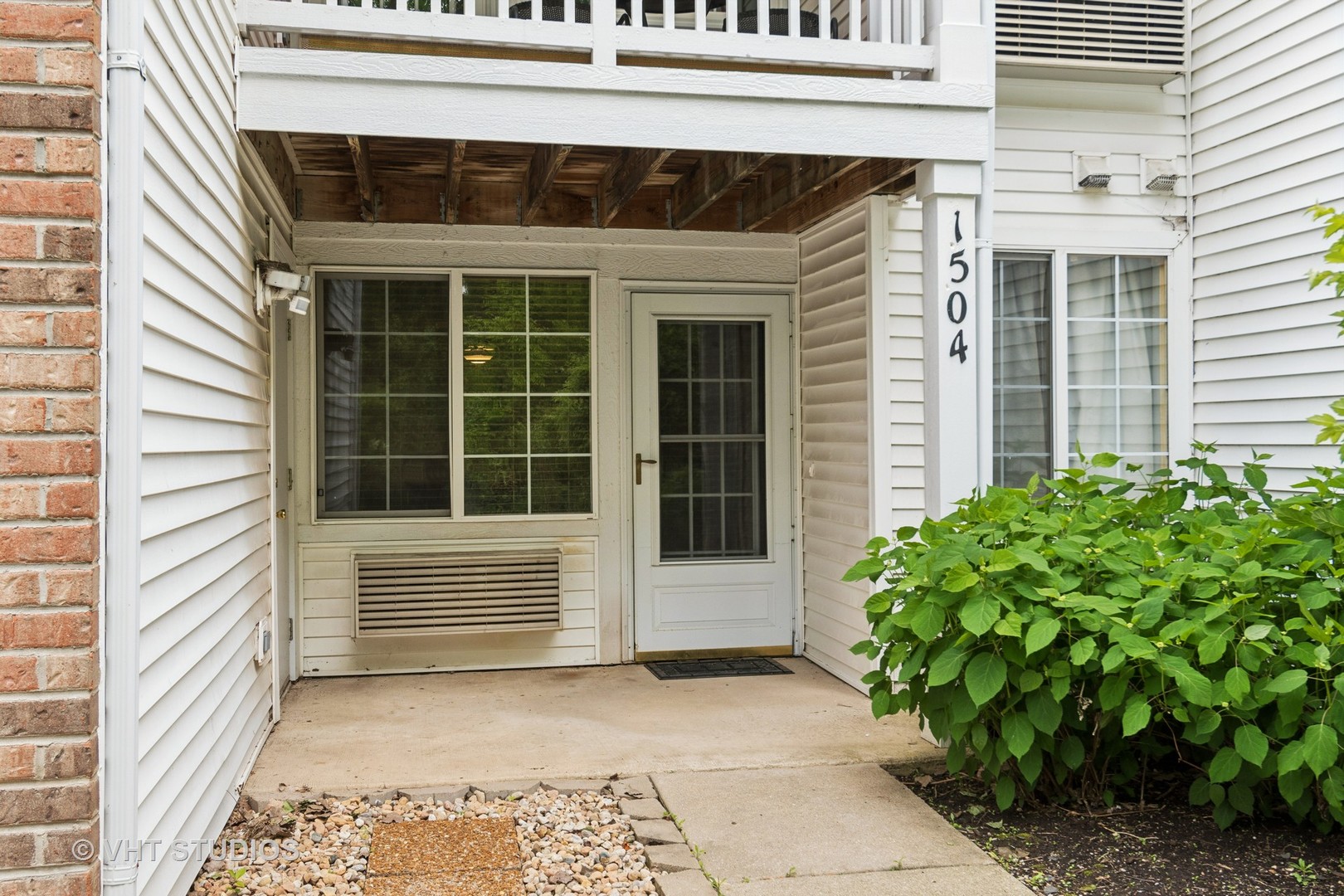 1504 McClure Road, Unit 1504 Aurora, IL 60505 - Photo 18 of 21 a front view of a house with a garden