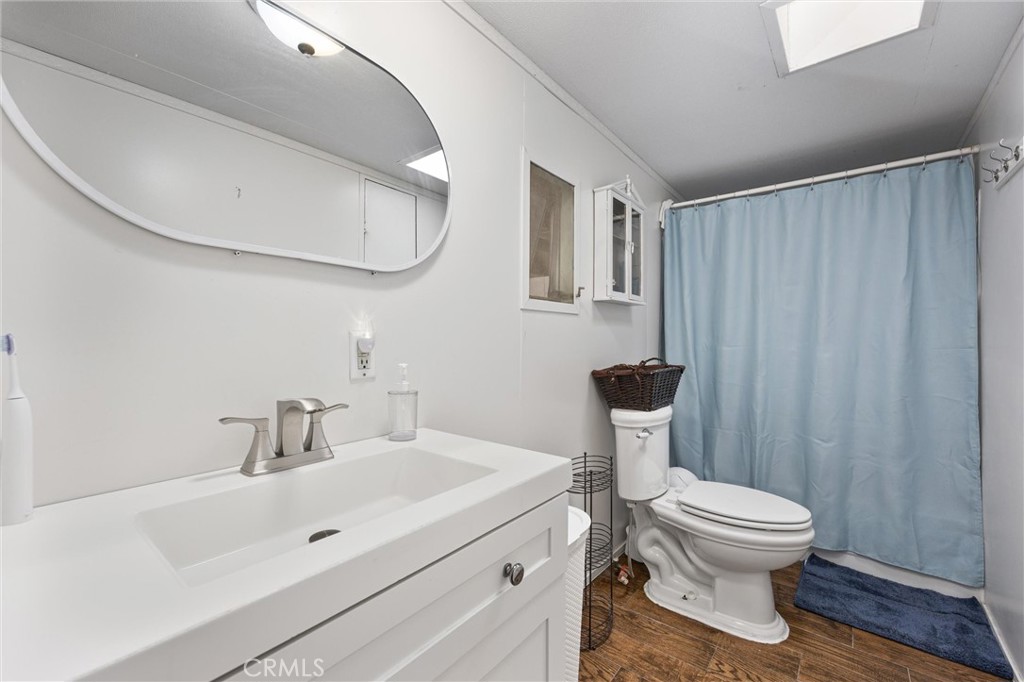 4730 Coronado Street West Bakersfield, CA 93314 - Photo 13 of 29 a bathroom with a toilet a sink and a mirror