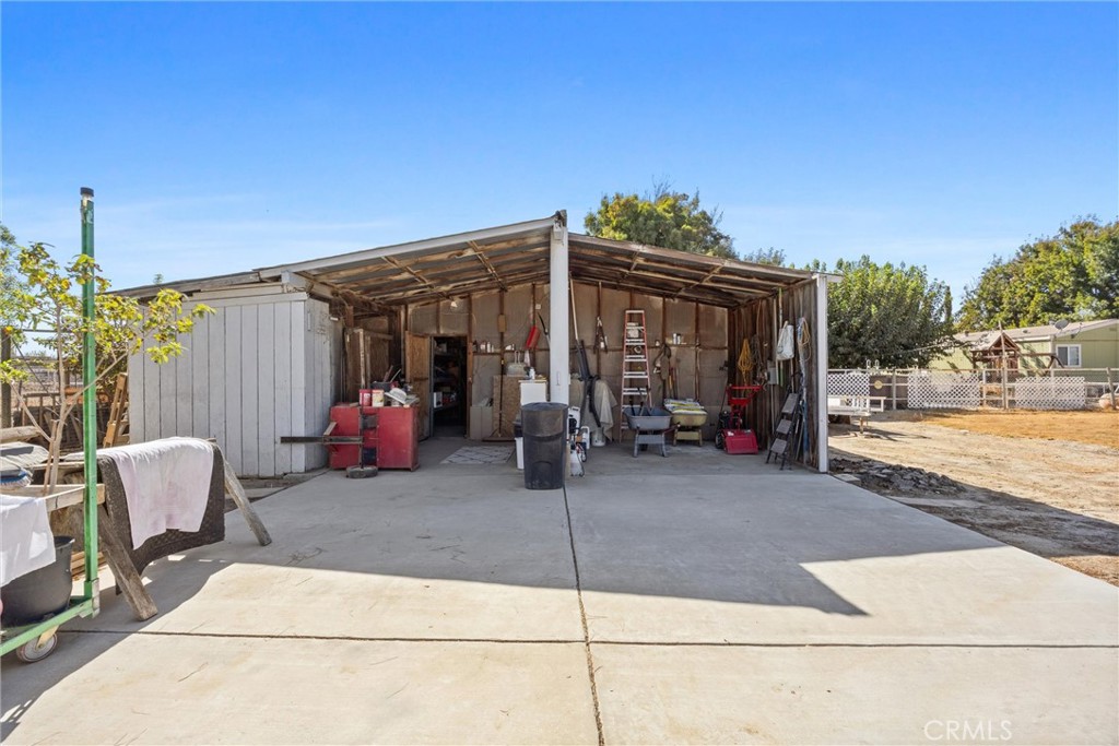 4730 Coronado Street West Bakersfield, CA 93314 - Photo 24 of 29 a view of a patio with table and chairs with wooden floor and fence