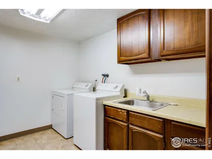 a utility room with sink dryer and washer