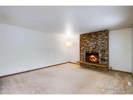a view of an empty room and fire place