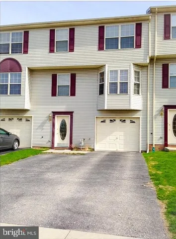a front view of building with yard