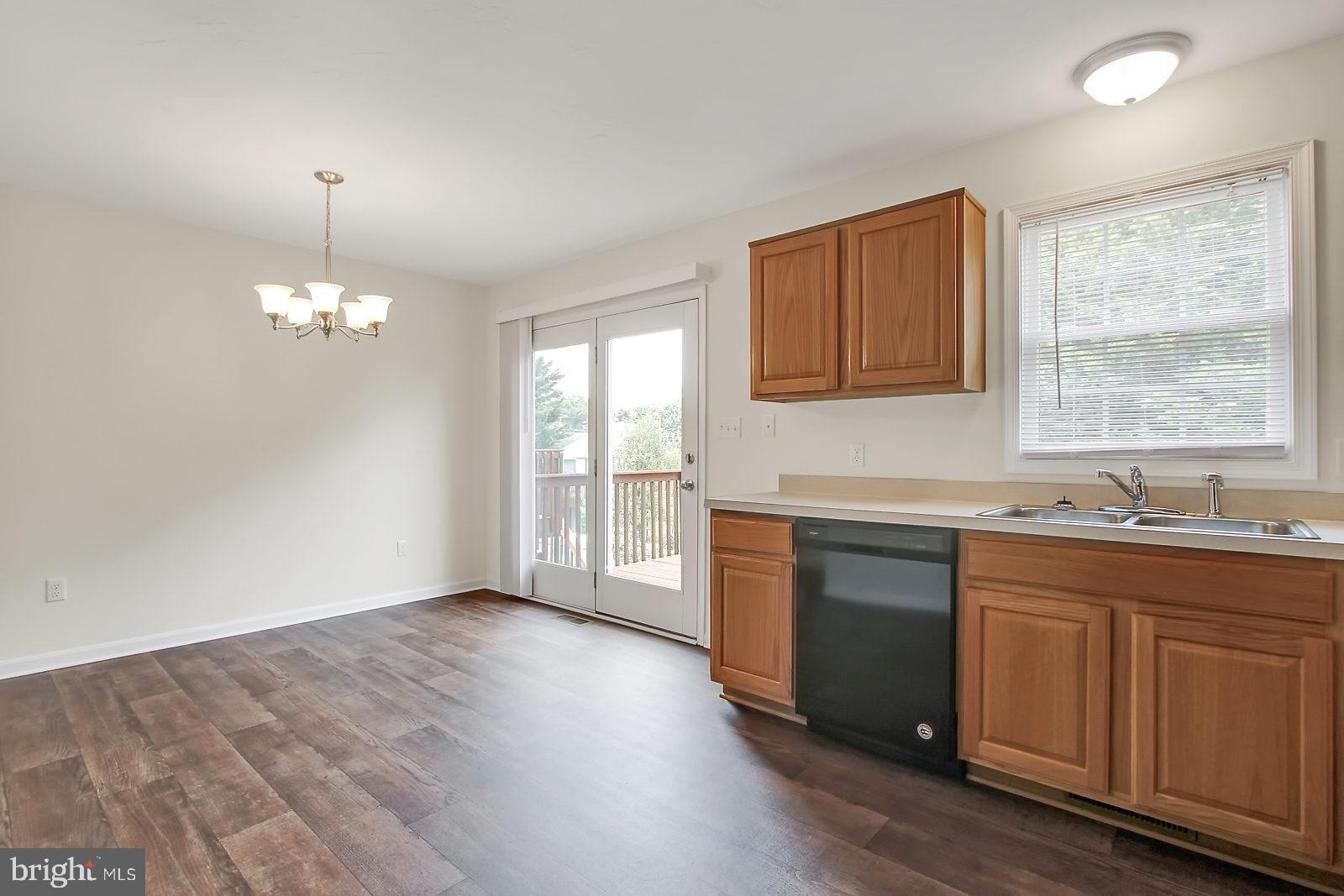 17 Grace Avenue Hanover, PA 17331 - Photo 2 of 13 a kitchen with granite countertop a stove a sink wooden floor and cabinets