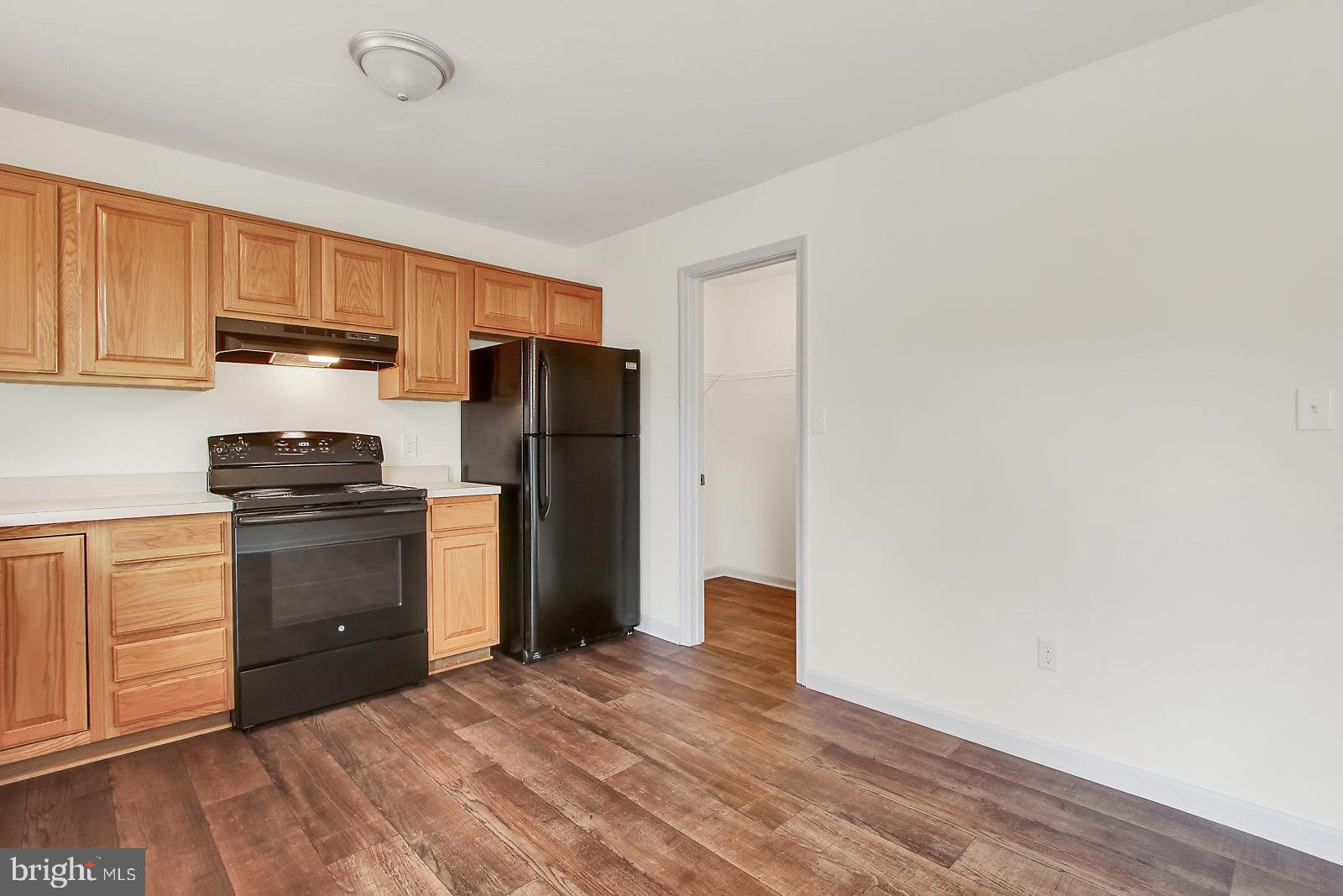 17 Grace Avenue Hanover, PA 17331 - Photo 4 of 13 a kitchen with a refrigerator stove and white cabinets