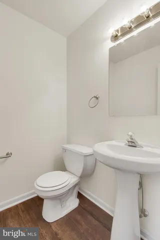 a white toilet sitting next to a bathroom sink