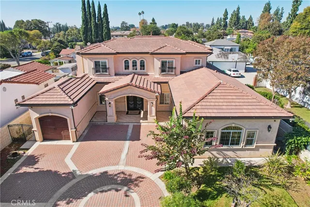 an aerial view of residential houses with outdoor space and street view