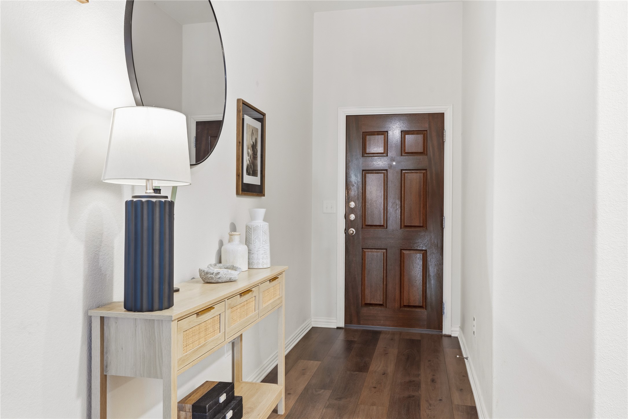 486 Pond View Pass Buda, TX 78610 - Photo 5 of 39 Entryway featuring a paneled wood door, wood-finish flooring, and white walls