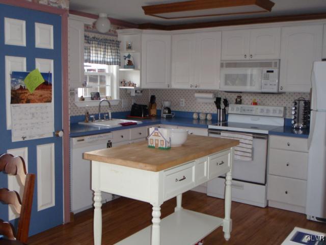 1049 Deemer Road Bath, PA 18014 - Photo 5 of 13 a kitchen with a stove a sink a dining table and chairs