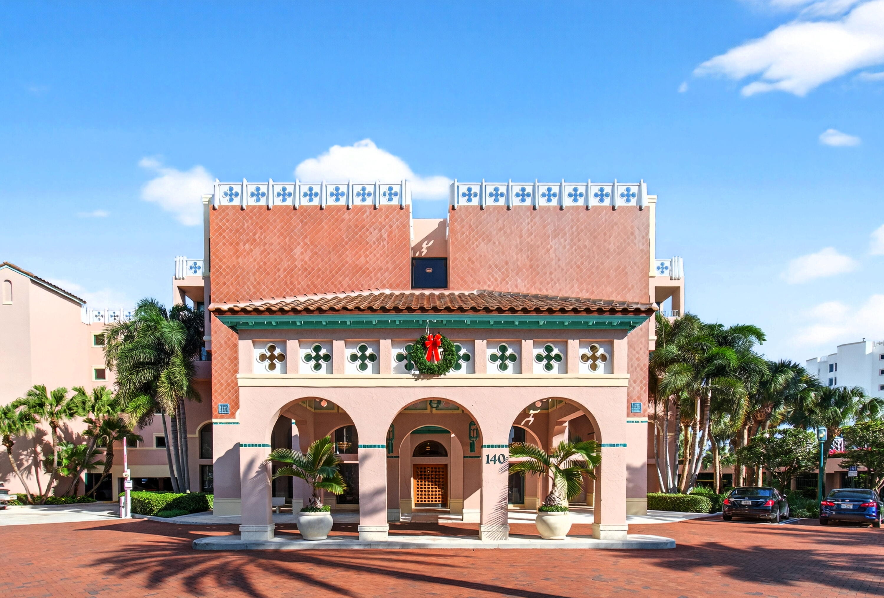 a front view of a building with glass windows and a table