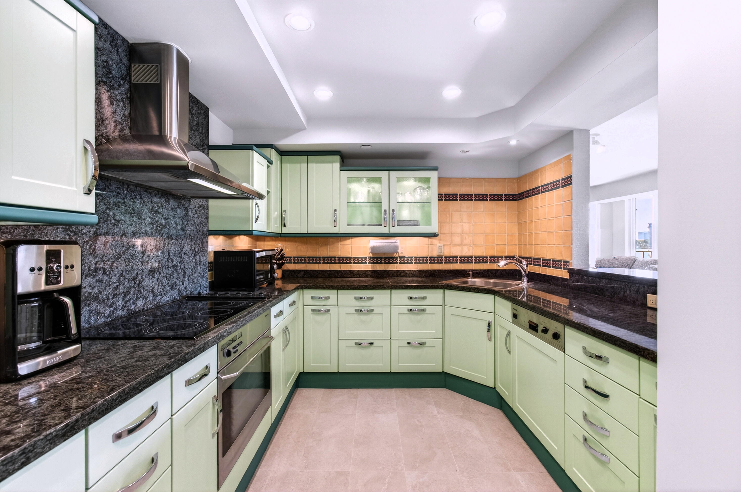 140 Southeast 5th Avenue, Unit 448 Boca Raton, FL 33432 - Photo 11 of 43 a kitchen with a sink stove and cabinets