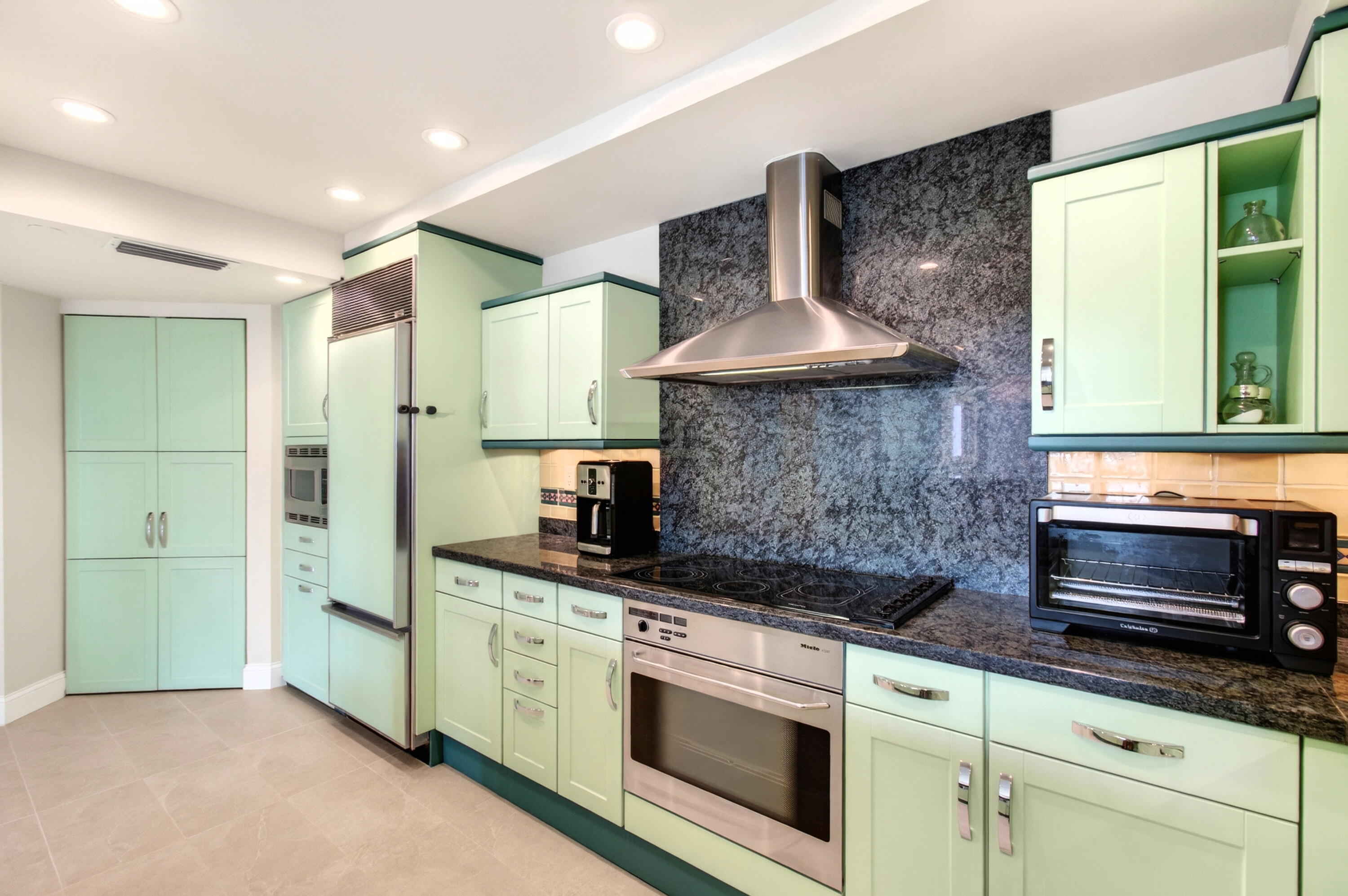 140 Southeast 5th Avenue, Unit 448 Boca Raton, FL 33432 - Photo 12 of 43 a kitchen with stainless steel appliances granite countertop a stove a sink and a refrigerator
