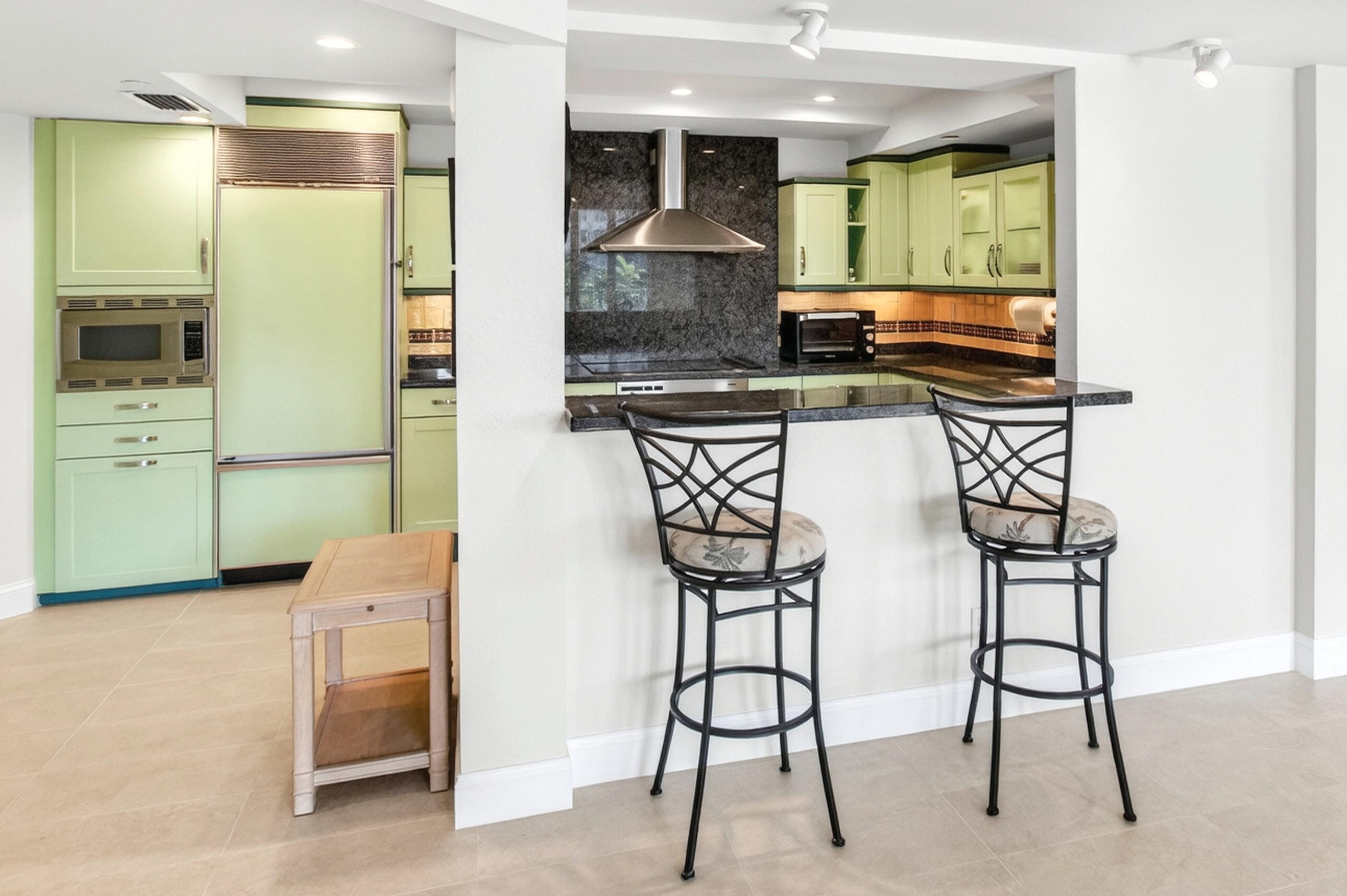 140 Southeast 5th Avenue, Unit 448 Boca Raton, FL 33432 - Photo 17 of 43 a kitchen with stainless steel appliances granite countertop a stove and a refrigerator