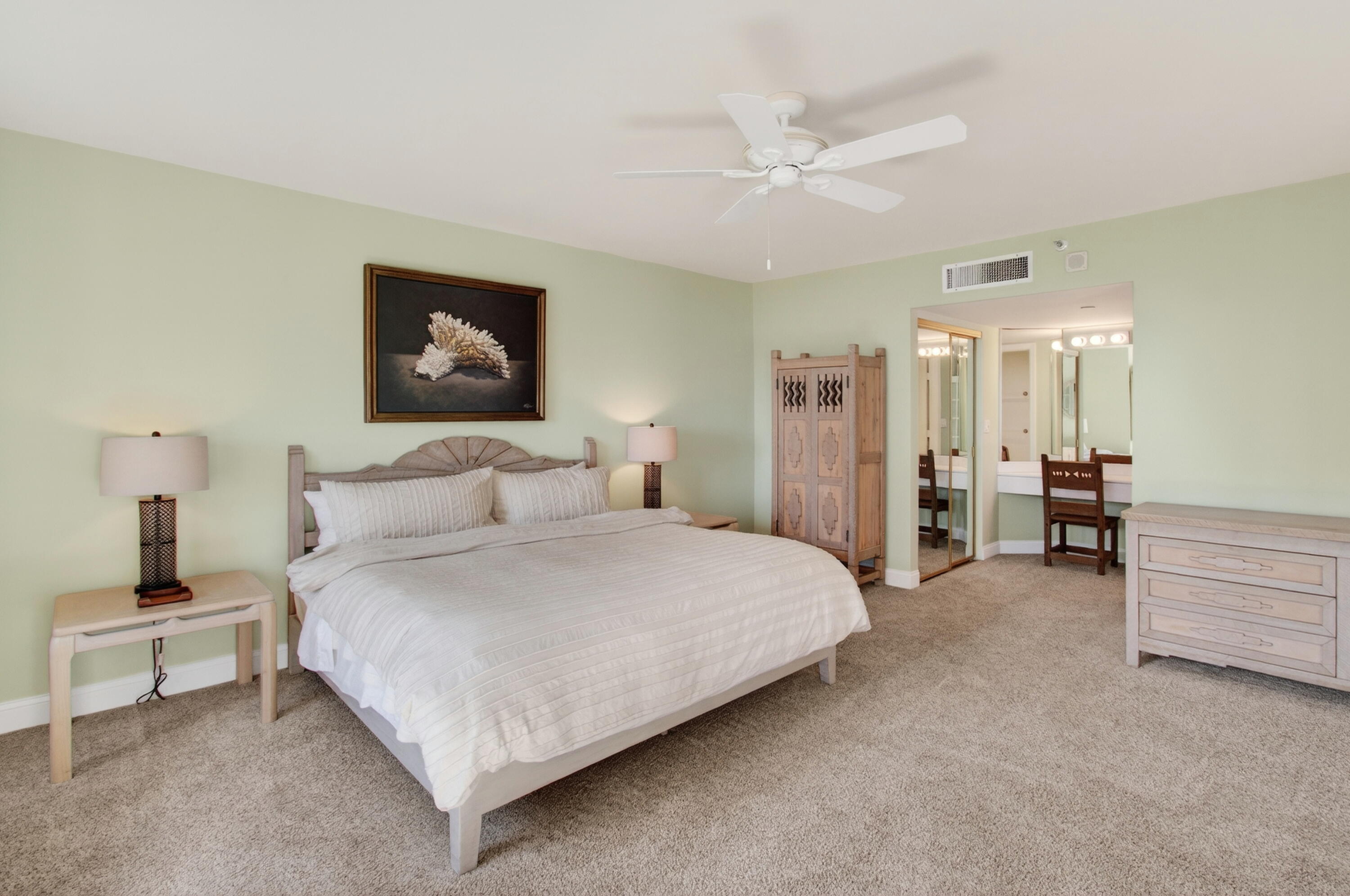 140 Southeast 5th Avenue, Unit 448 Boca Raton, FL 33432 - Photo 20 of 43 a spacious bedroom with a bed and a chandelier