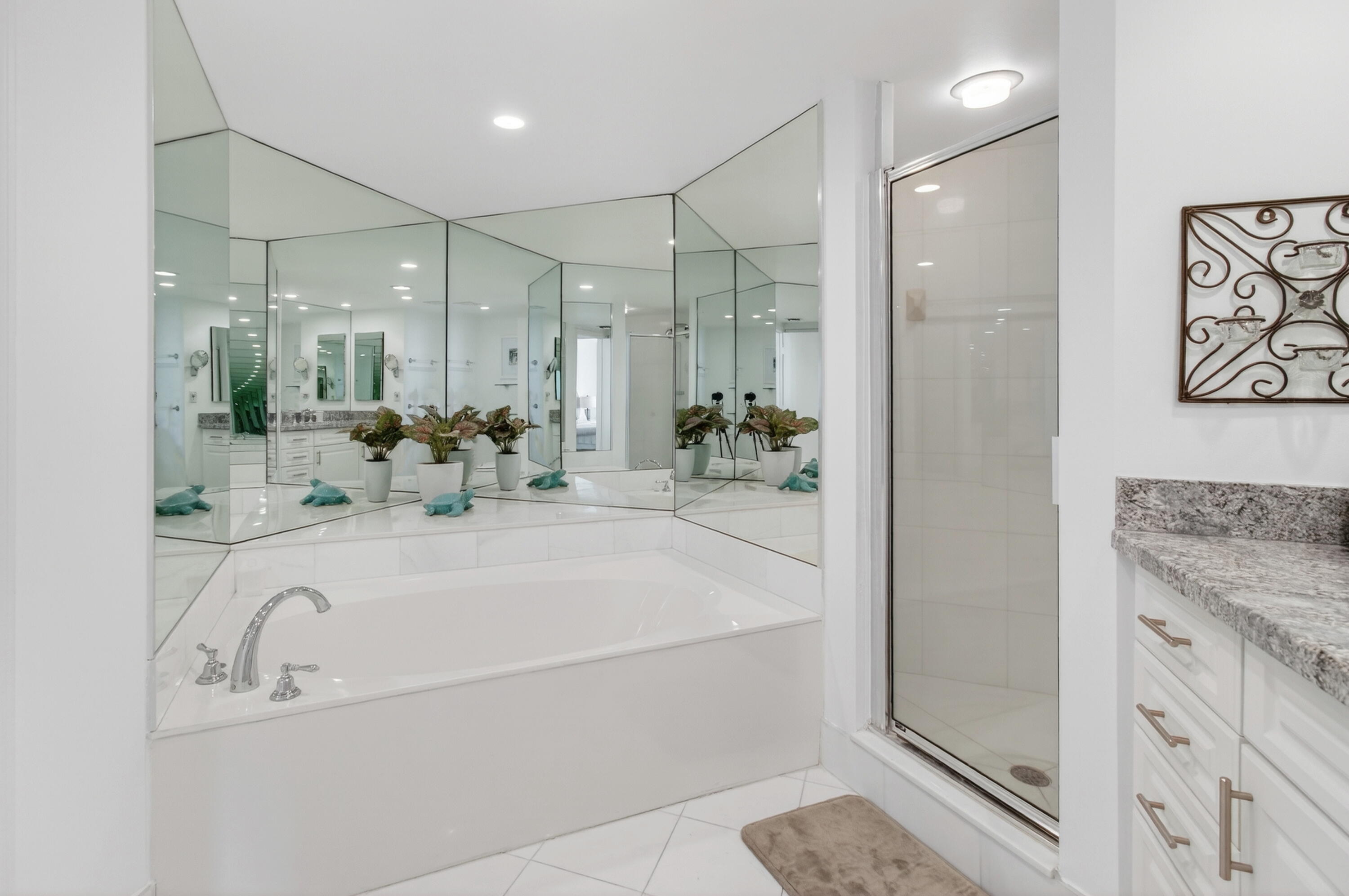 140 Southeast 5th Avenue, Unit 448 Boca Raton, FL 33432 - Photo 22 of 43 a bathroom with a tub sink and mirror