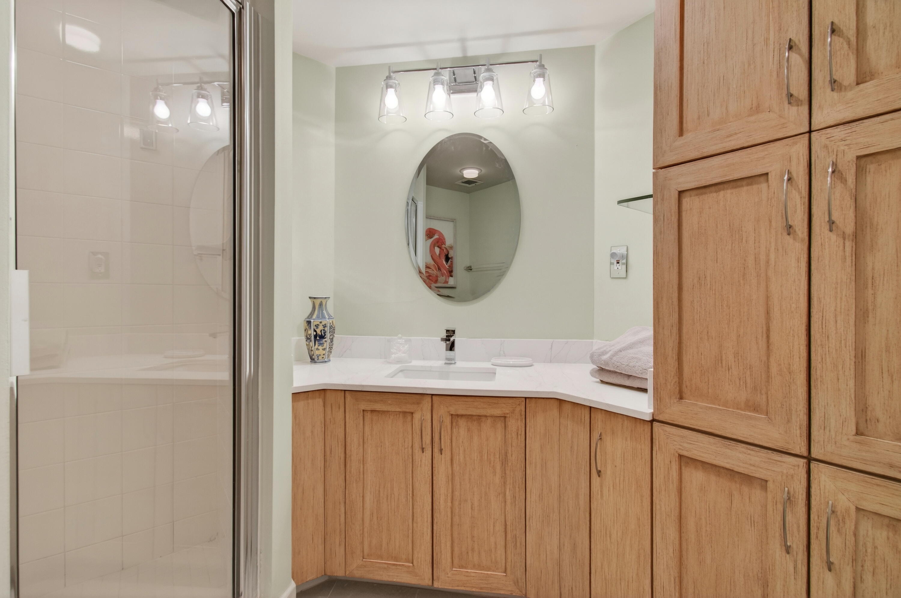 140 Southeast 5th Avenue, Unit 448 Boca Raton, FL 33432 - Photo 25 of 43 a bathroom with a sink and a mirror