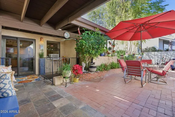 a living room with furniture kitchen view and a potted plant