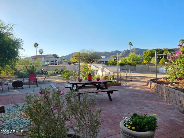 a kitchen with stainless steel appliances a table and chairs in it