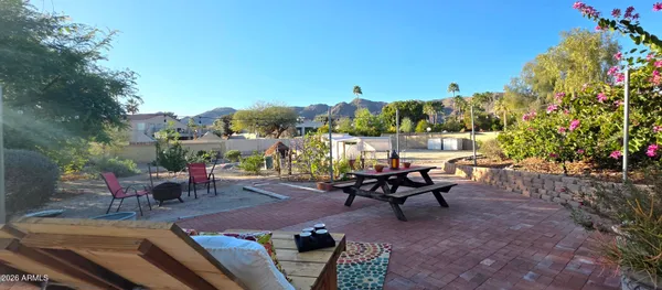 a kitchen with a stove a kitchen island with chairs and wooden cabinets
