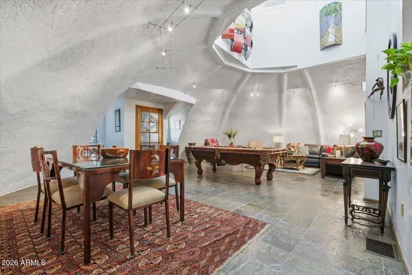 a view of a patio with table and chairs potted plants and large tree