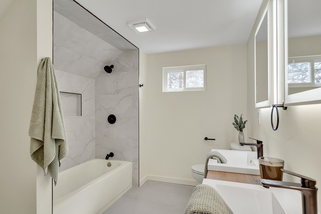56 Riverview Street Dedham, MA 02026 - Photo 15 of 29 a bath room with a bath tub and a shower