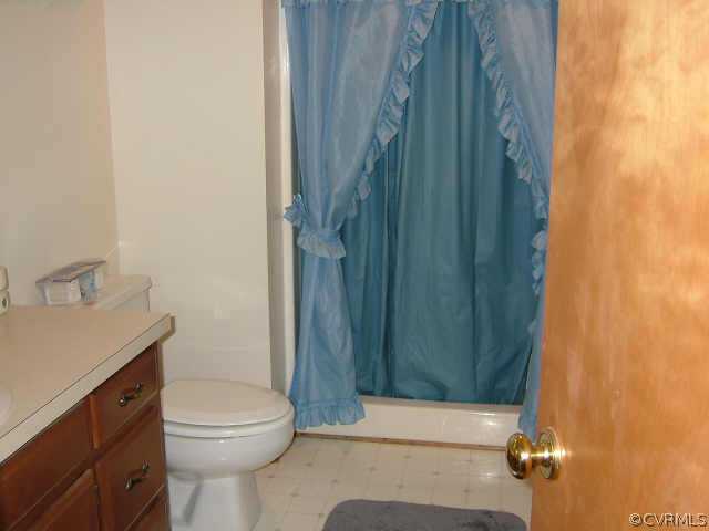 650 Edgar Road Hanover, VA 23069 - Photo 8 of 10 a bathroom with a sink a toilet and shower curtain