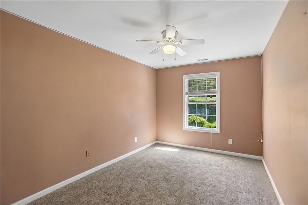 9720 Poole Road Villa Rica, GA 30180 - Photo 28 of 40 an empty room with windows and fan