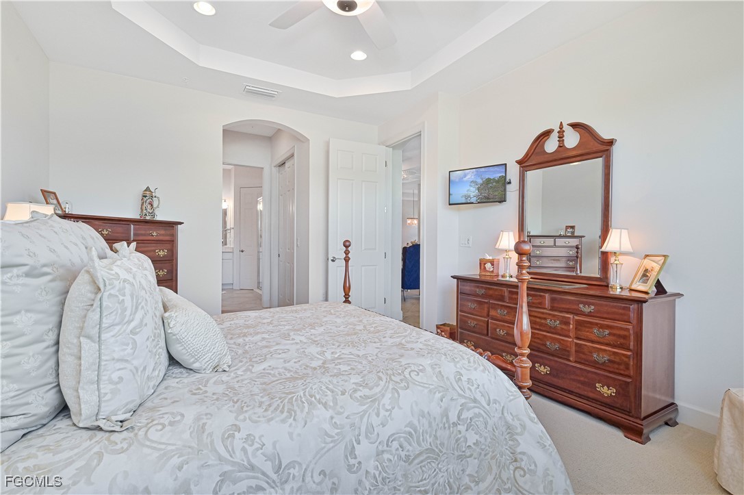 10251 Glastonbury Circle, Unit 201 Fort Myers, FL 33913 - Photo 32 of 45 a bedroom with a bed and a dresser