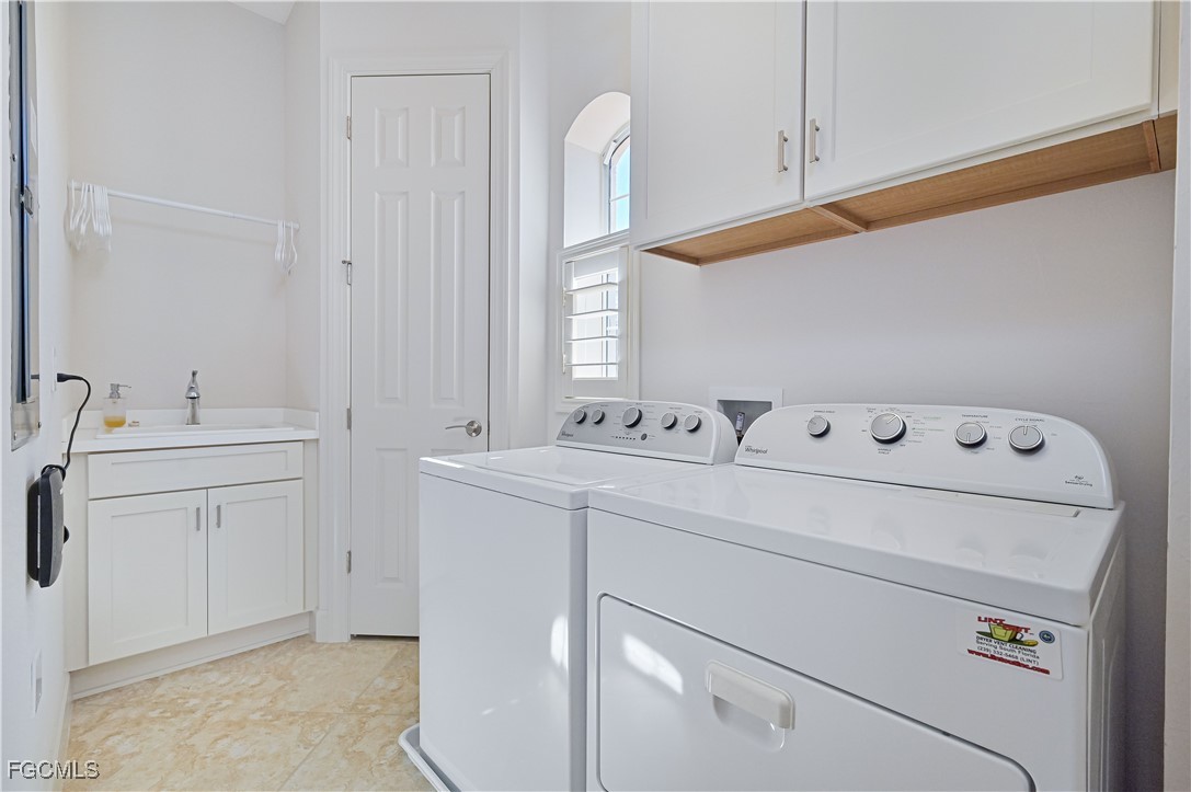 10251 Glastonbury Circle, Unit 201 Fort Myers, FL 33913 - Photo 40 of 45 a utility room with dryer and washer