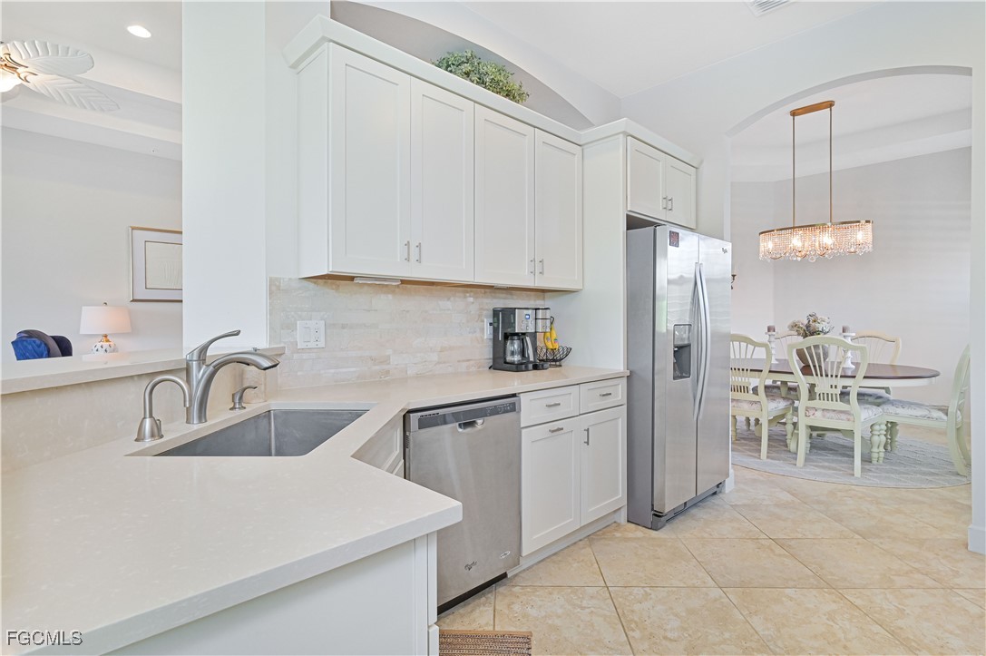 10251 Glastonbury Circle, Unit 201 Fort Myers, FL 33913 - Photo 9 of 45 a kitchen with stainless steel appliances a refrigerator sink and cabinets
