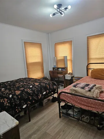 a bedroom with bed and window