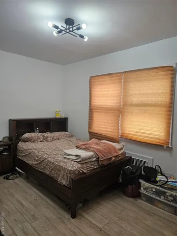 a bedroom with bed and window