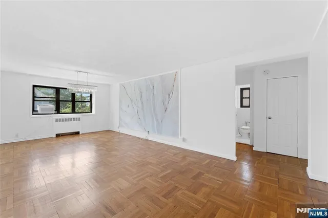 an empty room with windows and closet