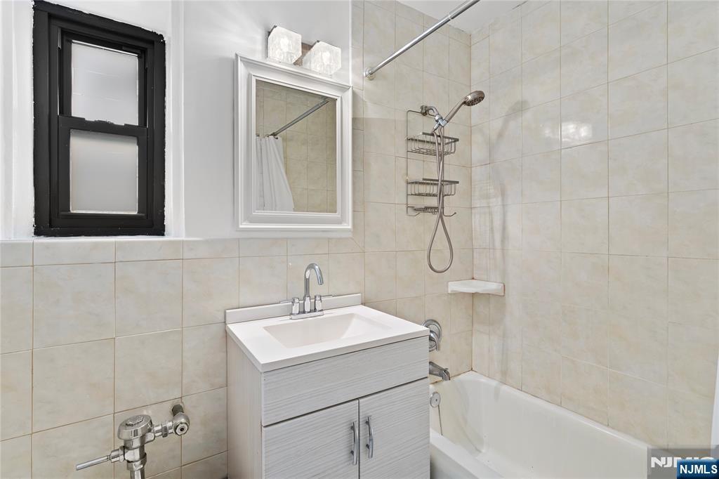 208 Anderson Street, Unit S2A Hackensack, NJ 07601 - Photo 18 of 23 a bathroom with a sink a toilet and shower