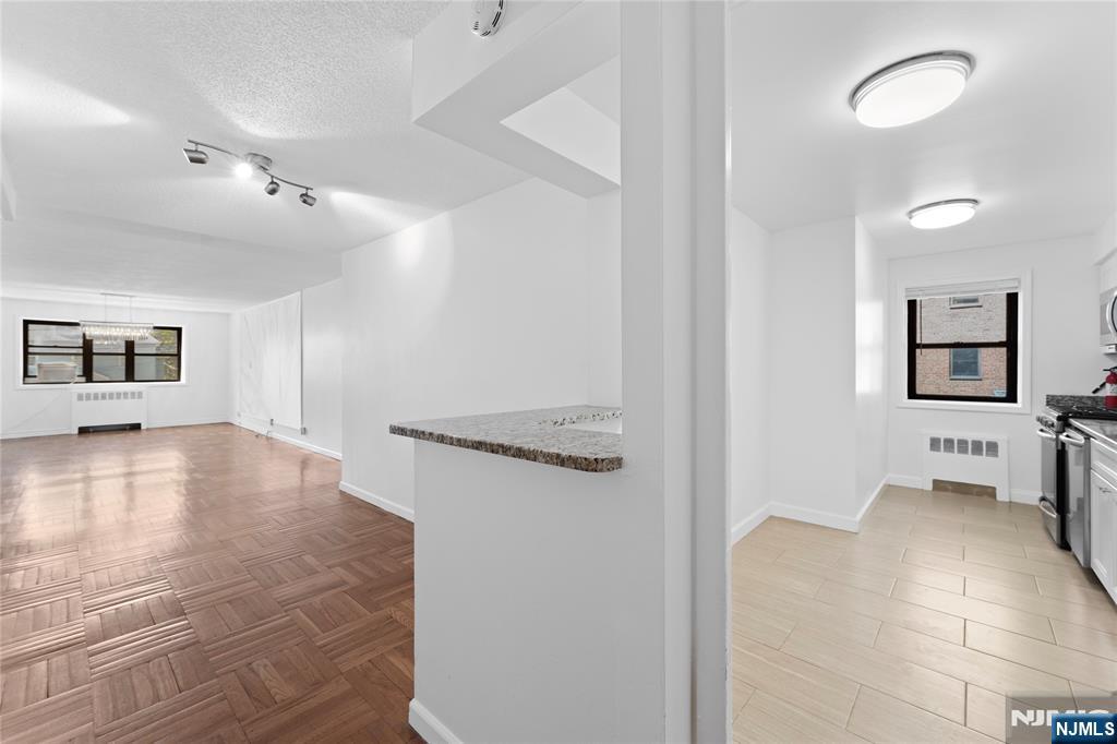 208 Anderson Street, Unit S2A Hackensack, NJ 07601 - Photo 4 of 23 a view of a livingroom with a couch and a stove top oven
