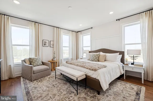 a spacious bedroom with a bed and a couch