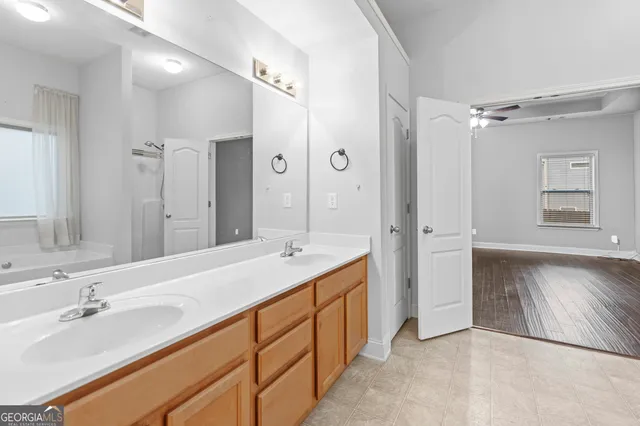 a spacious bathroom with a double vanity sink mirror and double