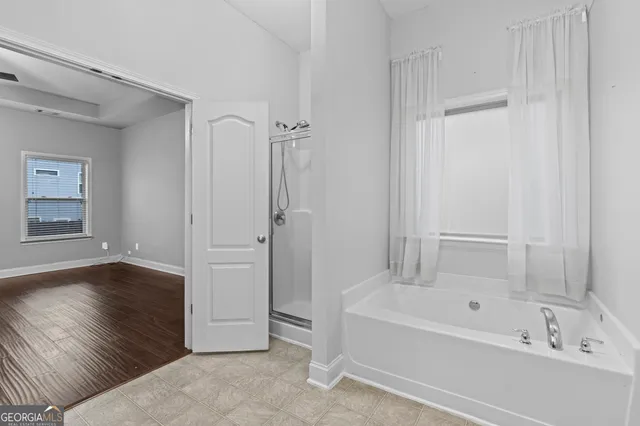 a bathroom with a bathtub and a shower