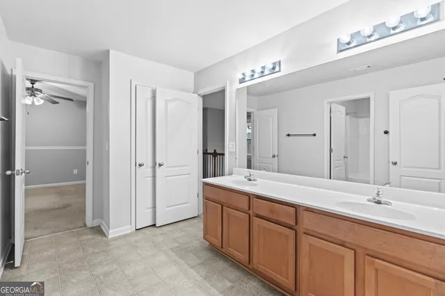 a spacious bathroom with a double vanity sink mirror and double