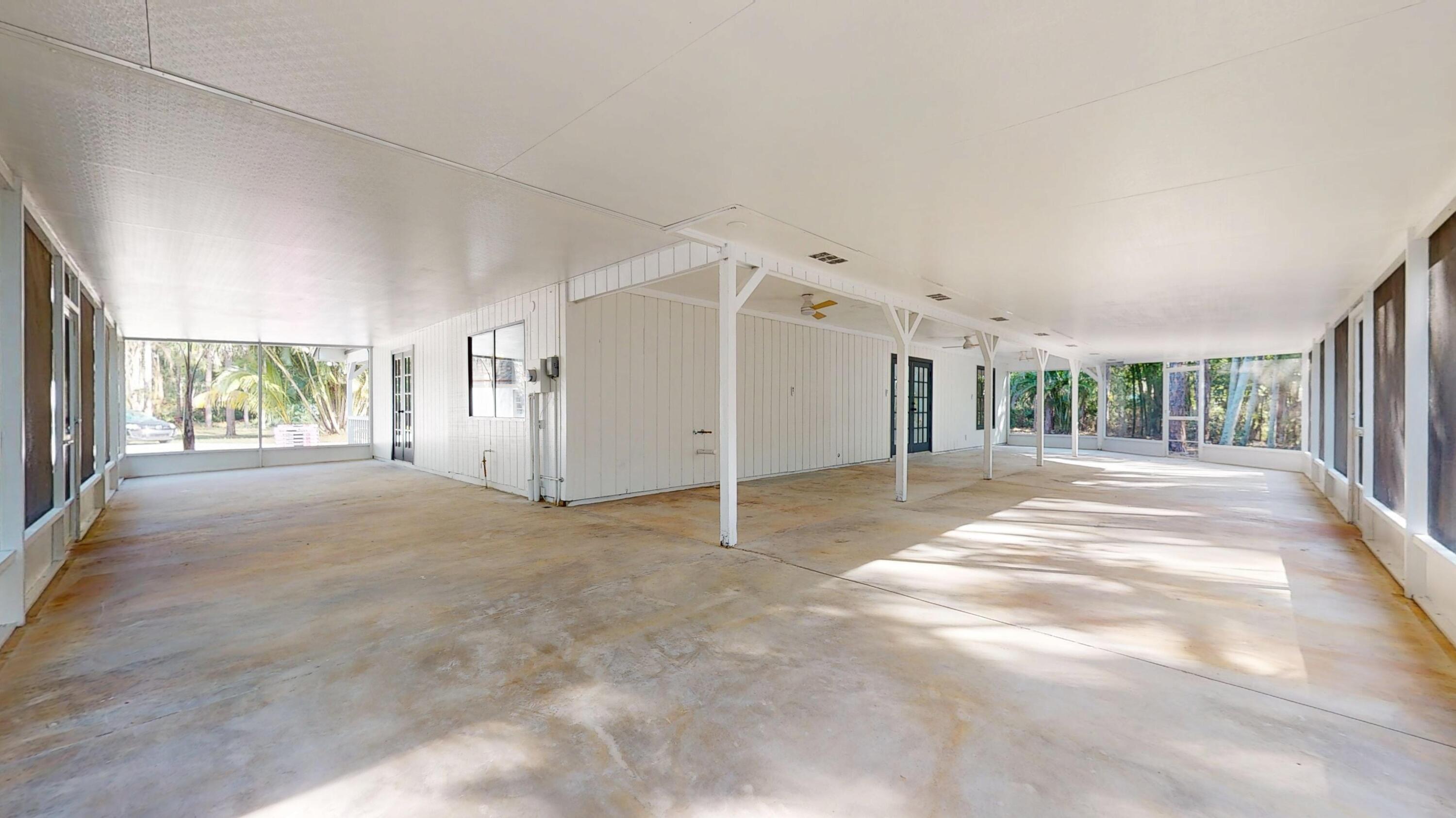 13018 153rd Road North Jupiter, FL 33478 - Photo 11 of 37 a view of a big room with windows and pillars in it