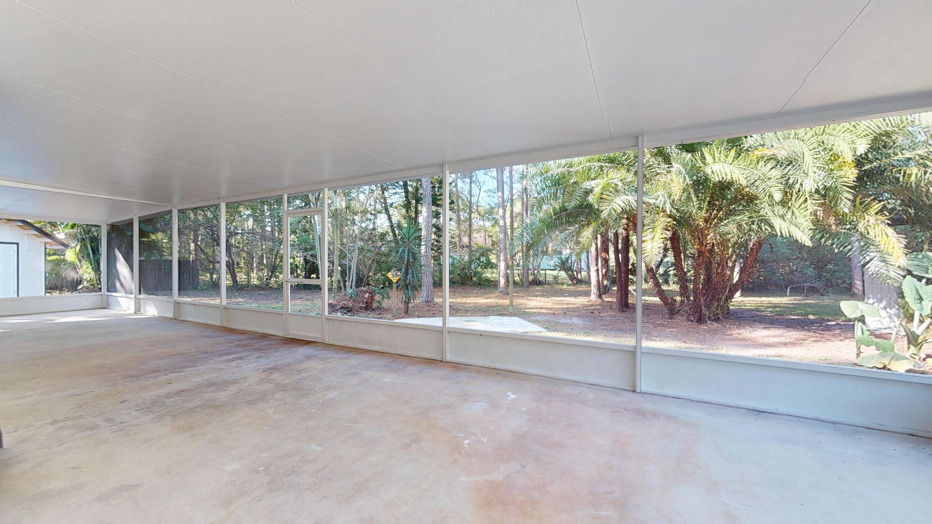 13018 153rd Road North Jupiter, FL 33478 - Photo 14 of 37 a view of a house with porch and a yard