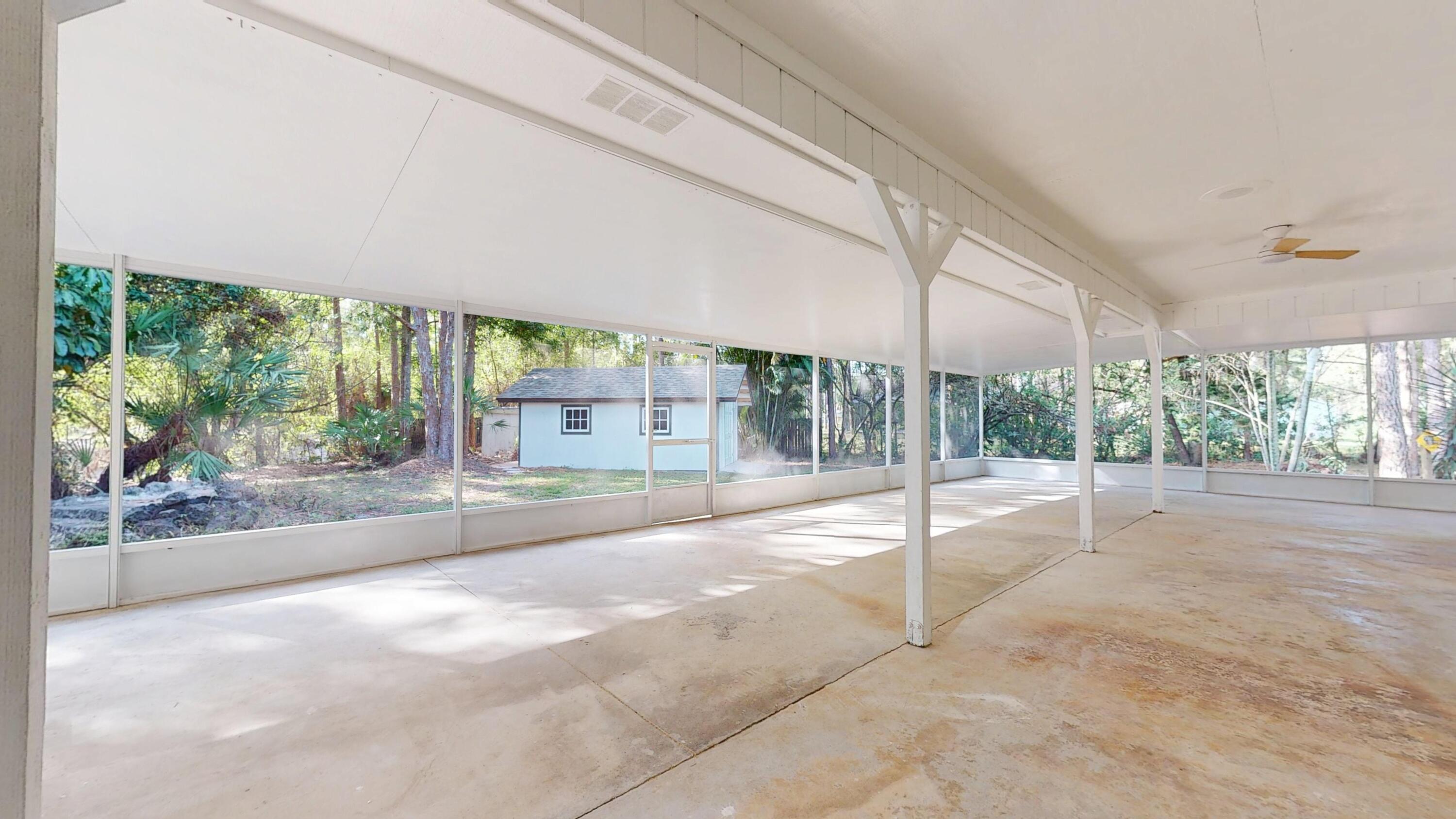 13018 153rd Road North Jupiter, FL 33478 - Photo 16 of 37 a view of a porch and a yard