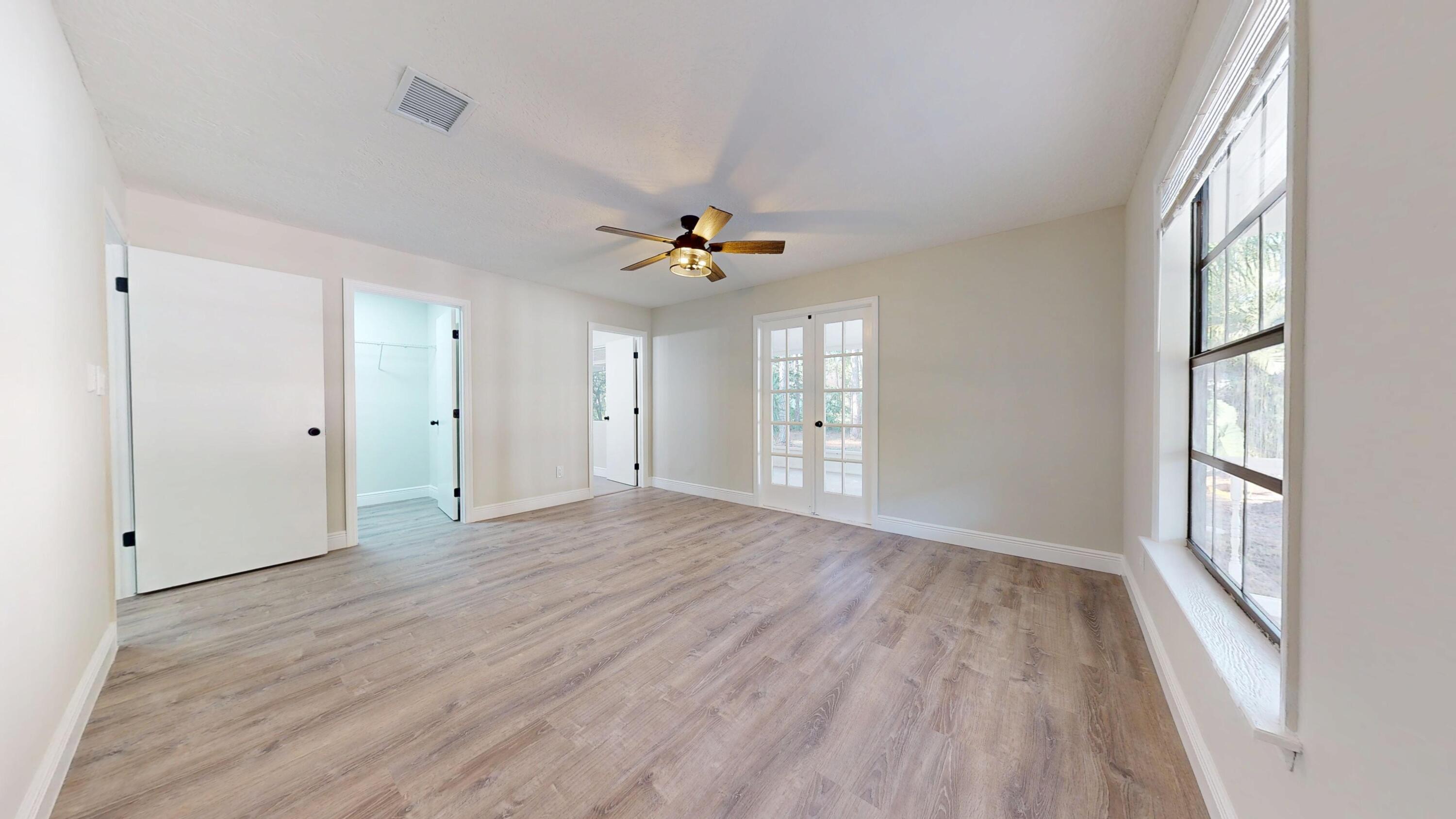 13018 153rd Road North Jupiter, FL 33478 - Photo 17 of 37 a view of an empty room with a window