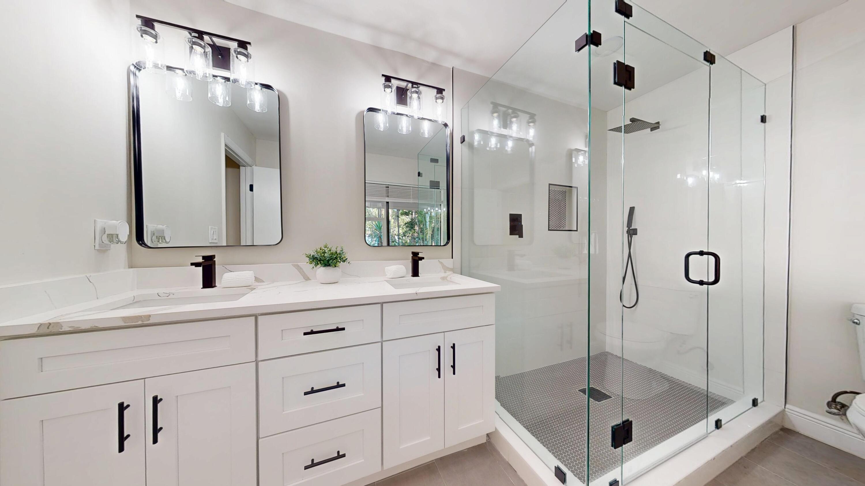13018 153rd Road North Jupiter, FL 33478 - Photo 20 of 37 a bathroom with a shower sink and mirror