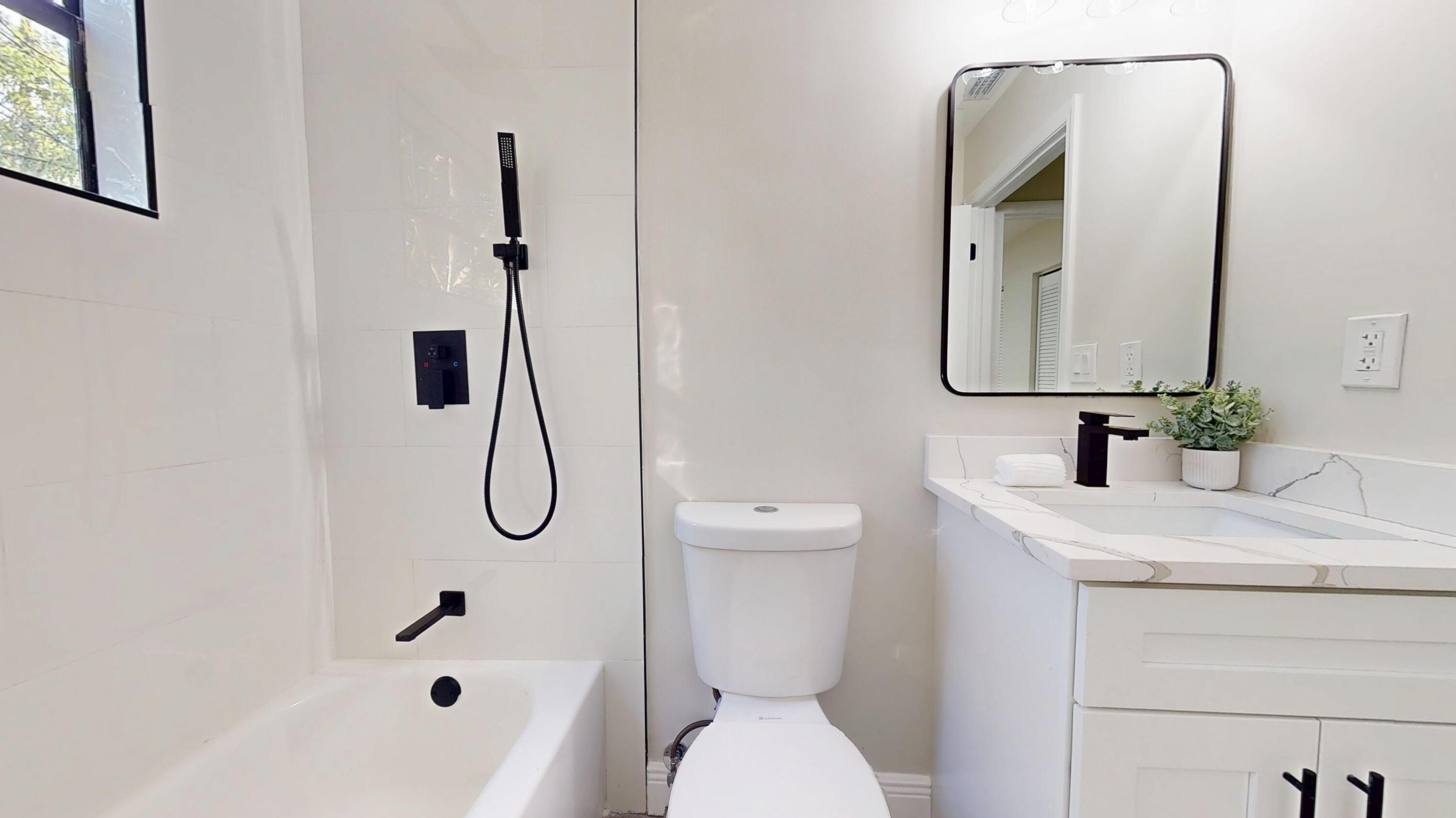 13018 153rd Road North Jupiter, FL 33478 - Photo 24 of 37 a bathroom with a granite countertop sink toilet and shower