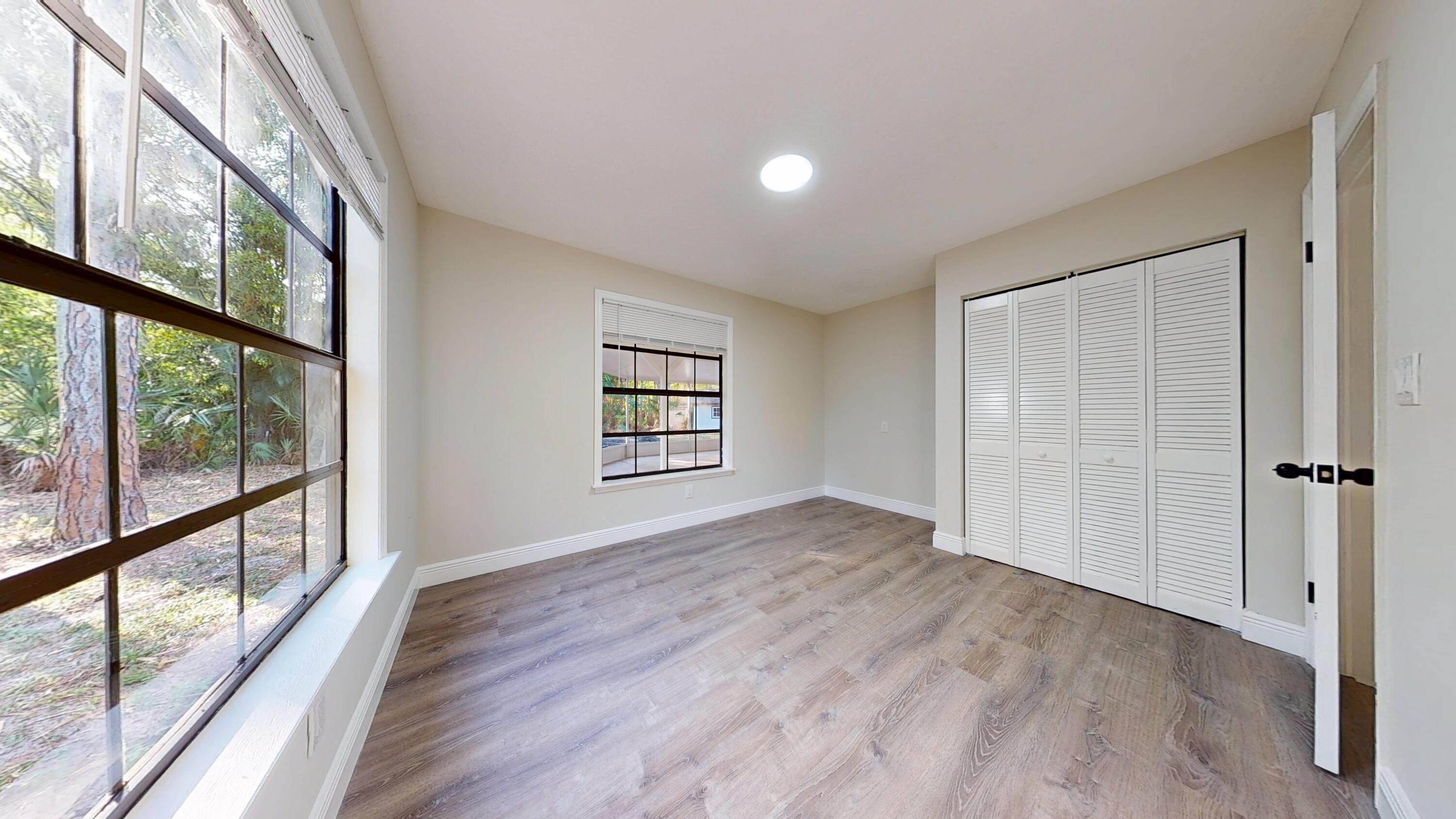 13018 153rd Road North Jupiter, FL 33478 - Photo 27 of 37 wooden floor in an empty room with a window