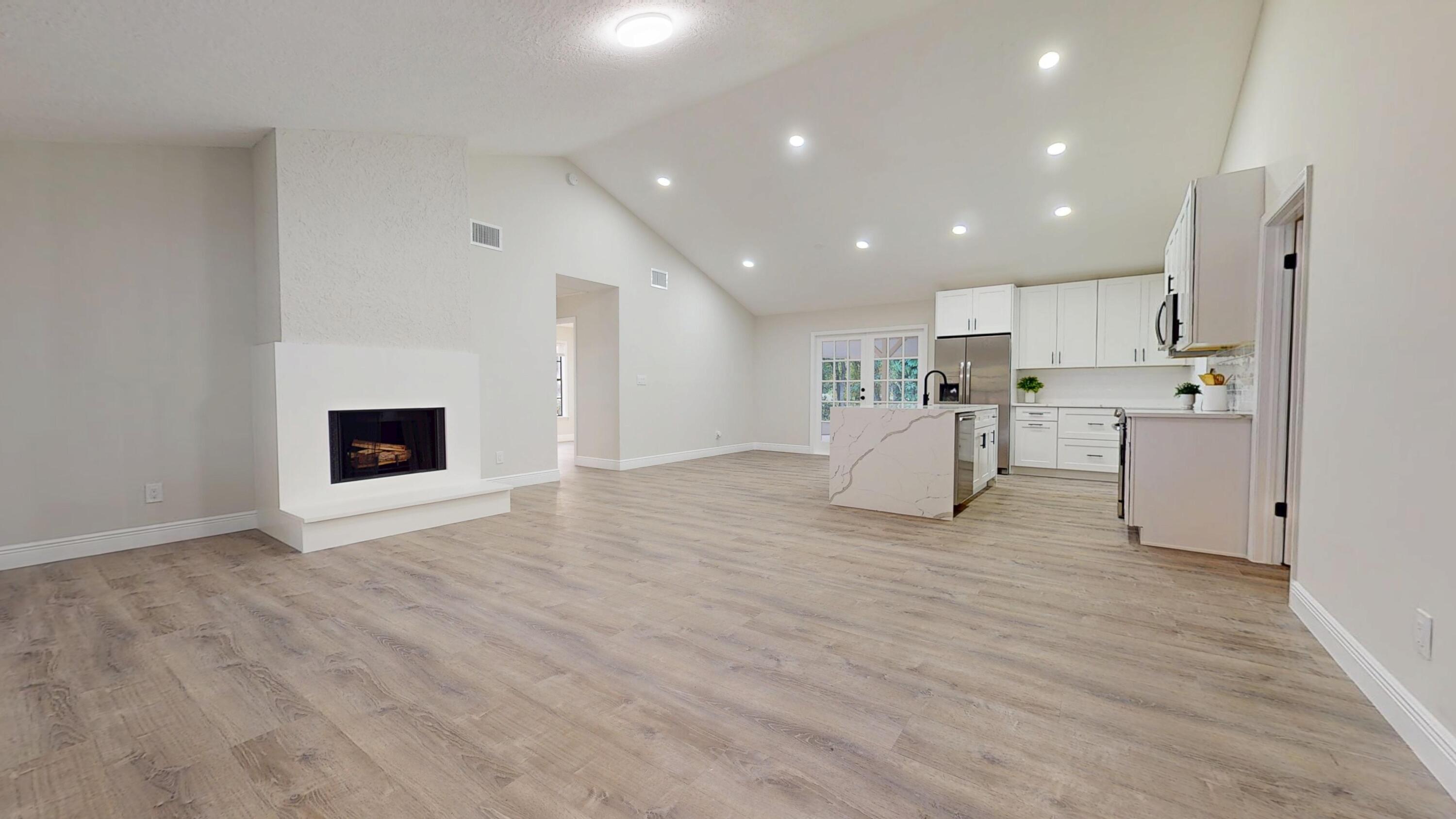 13018 153rd Road North Jupiter, FL 33478 - Photo 3 of 37 a view of a kitchen with a sink wooden floor and a refrigerator