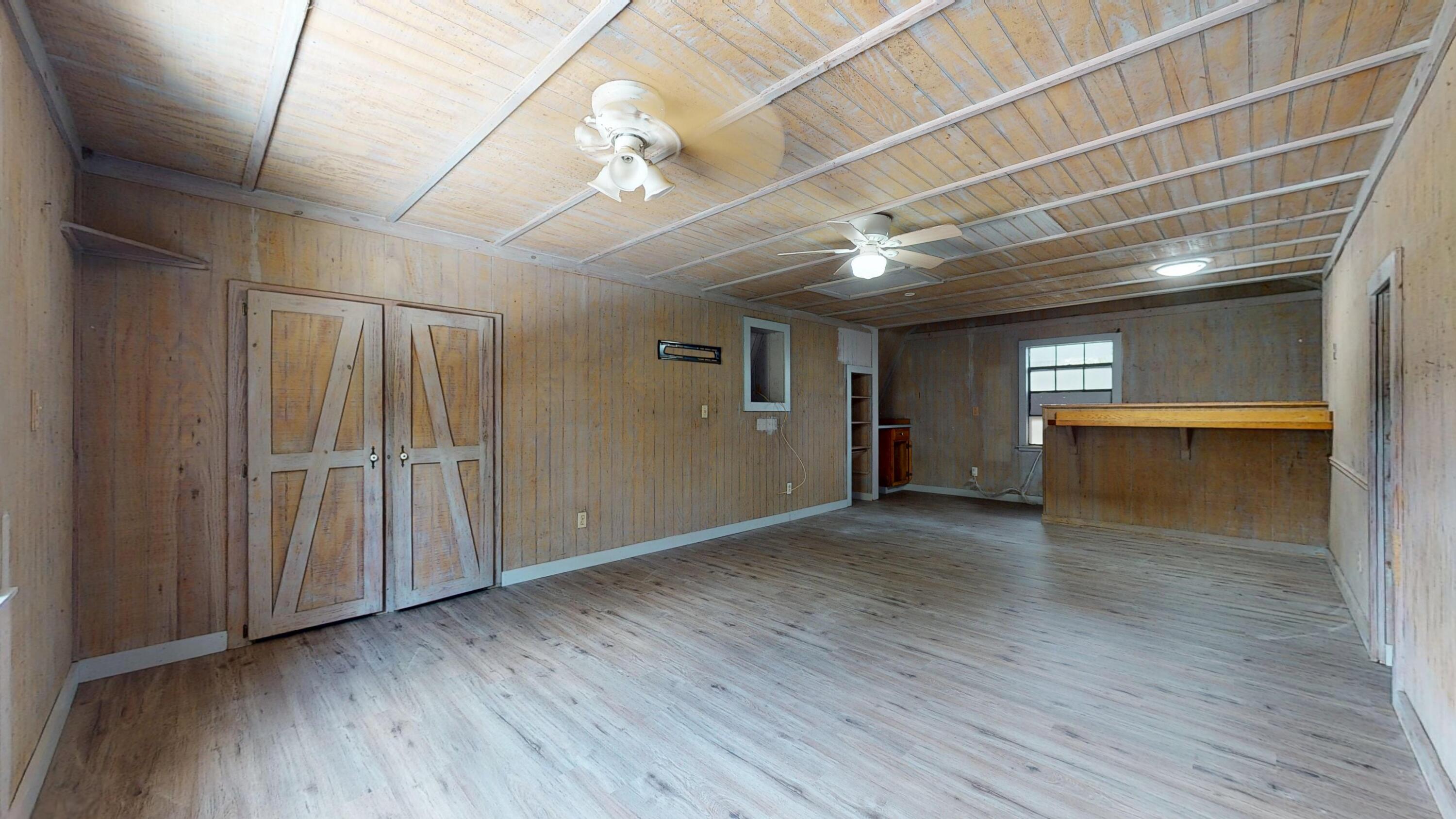 13018 153rd Road North Jupiter, FL 33478 - Photo 32 of 37 an empty room with wooden floor and windows