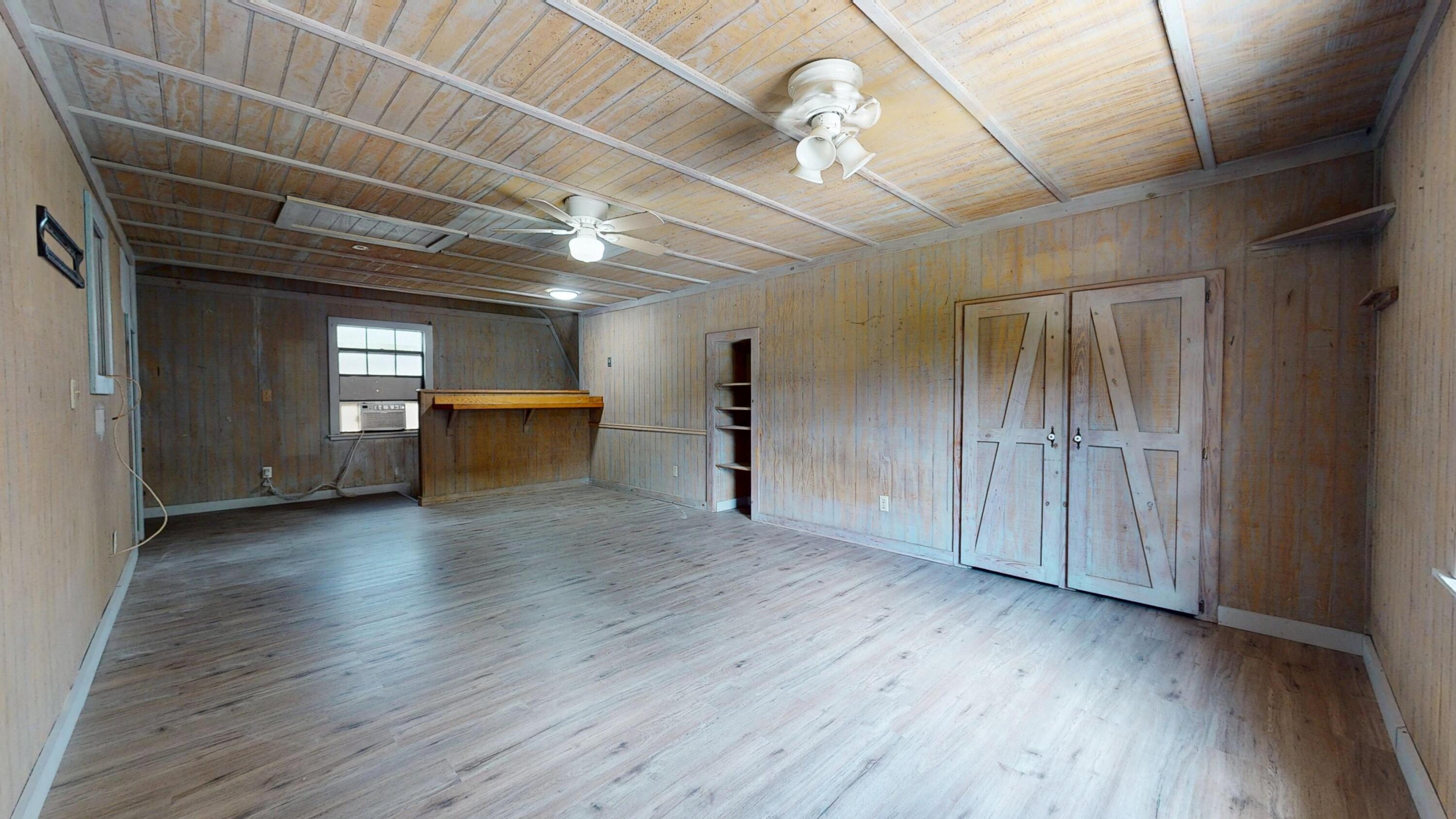 13018 153rd Road North Jupiter, FL 33478 - Photo 33 of 37 wooden floor in an empty room with a window